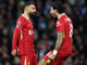 Deux joueurs de football discutent sur le terrain.