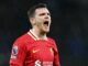 Joueur de football criant, maillot rouge Liverpool.