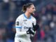 Joueur de football applaudissant sur le terrain.