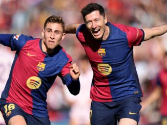 Footballers jubilant after scoring.