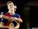 Deux joueurs de football s'embrassant sur le terrain.
