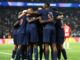 Joueurs de football s'embrassant sur le terrain.