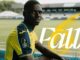 Joueur de football assis dans un stade.