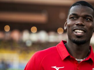 Personne souriante en polo rouge.