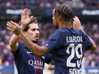 Deux footballeurs célèbrent un but ensemble.
