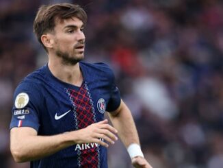 Joueur de football sur le terrain, maillot bleu PSG.