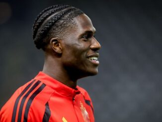 Joueur de football souriant en maillot rouge