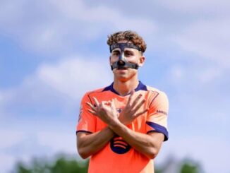 Footballeur en maillot orange avec masque facial