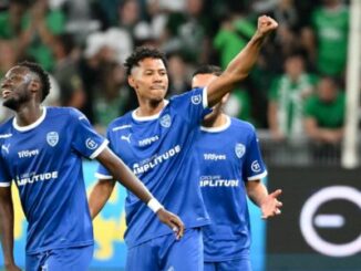 Joueurs de football en bleu célébrant un but