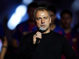 Homme parlant au micro devant équipe de football